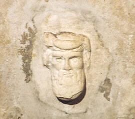 Detail of the head of Dionysus below a graffito